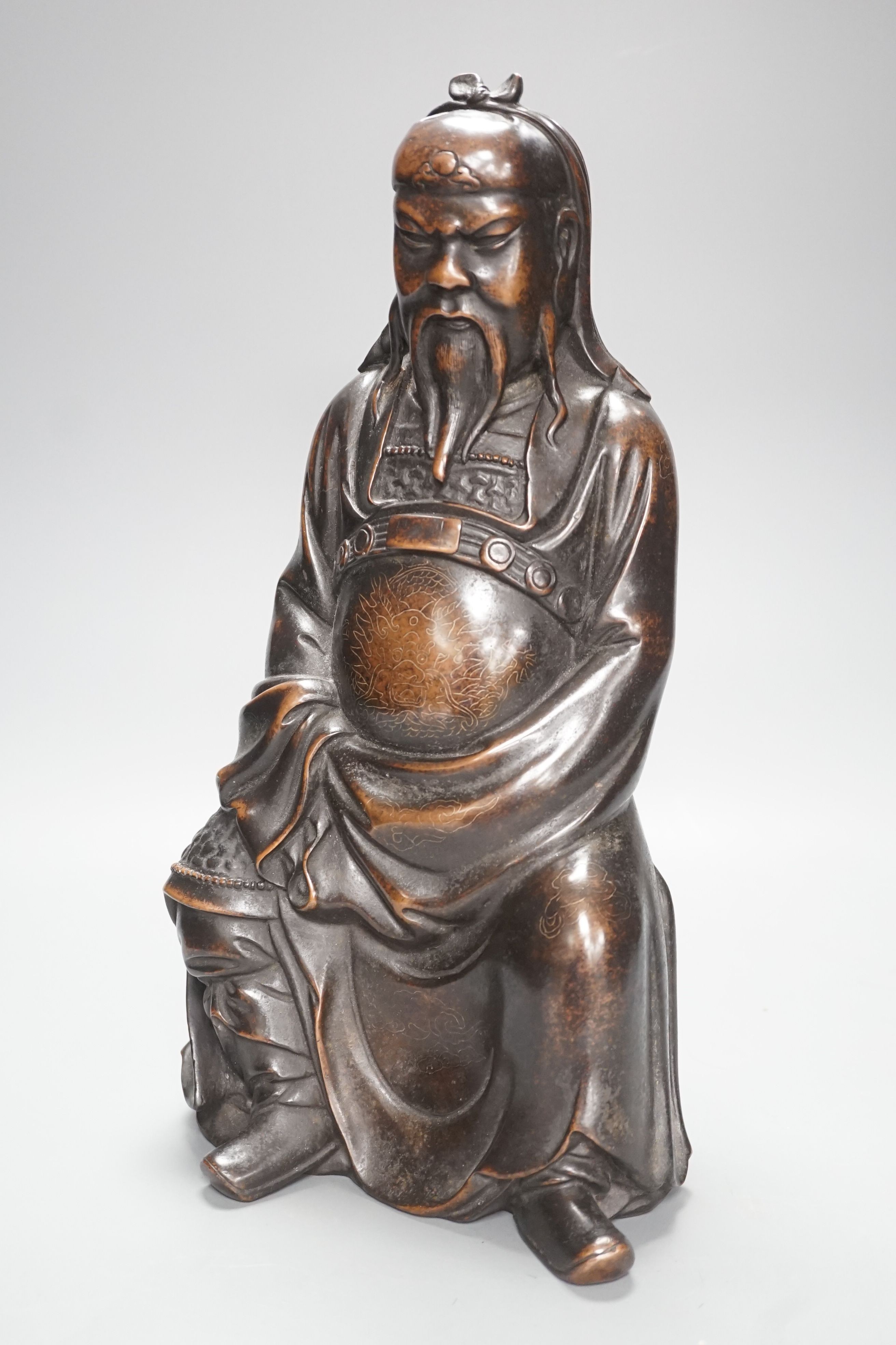 A large Chinese silver inlaid bronze seated figure of Guandi, Shishou mark, height 36cm